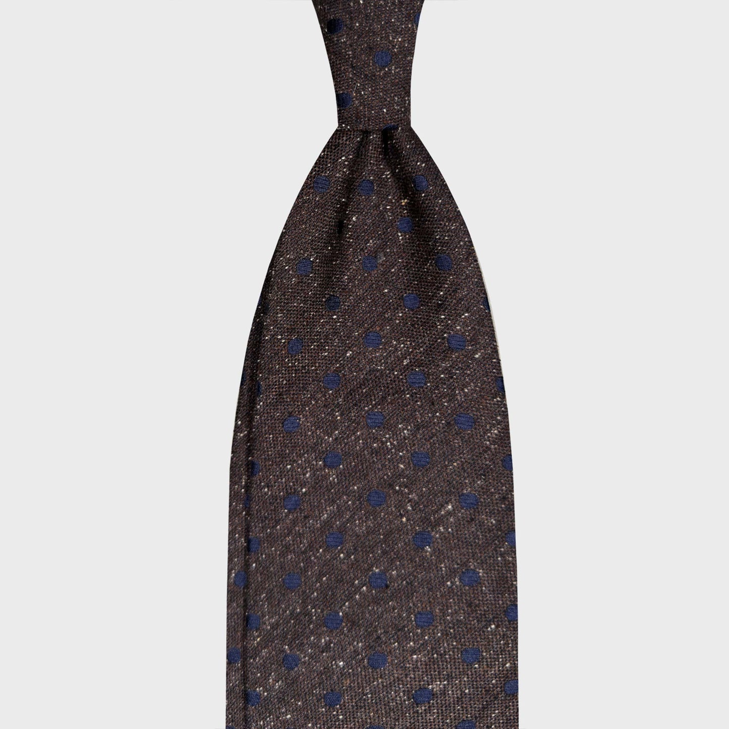 Coffee Brown Donegal Effect Tie Italian Ties Switzerland. Coffee brown melange background and cobalt blue pois. Handmade in Italy and selected by Wools Boutique Uomo for refined menswear in Geneva and Switzerland.