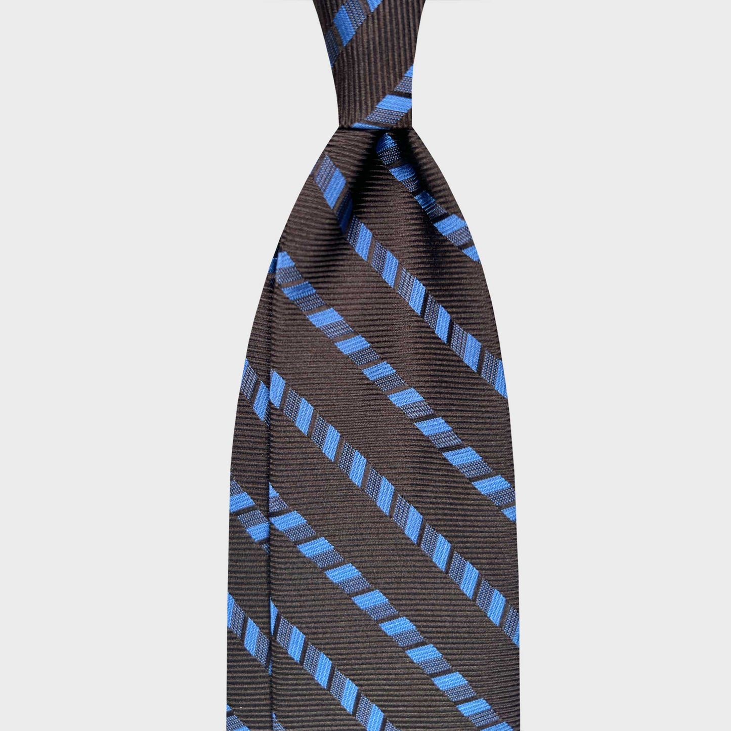 Coffee brown silk tie featuring classic regimental stripes in sky blue tones. A timeless business essential crafted in Italy, perfect for formal office wear and refined professional styling.