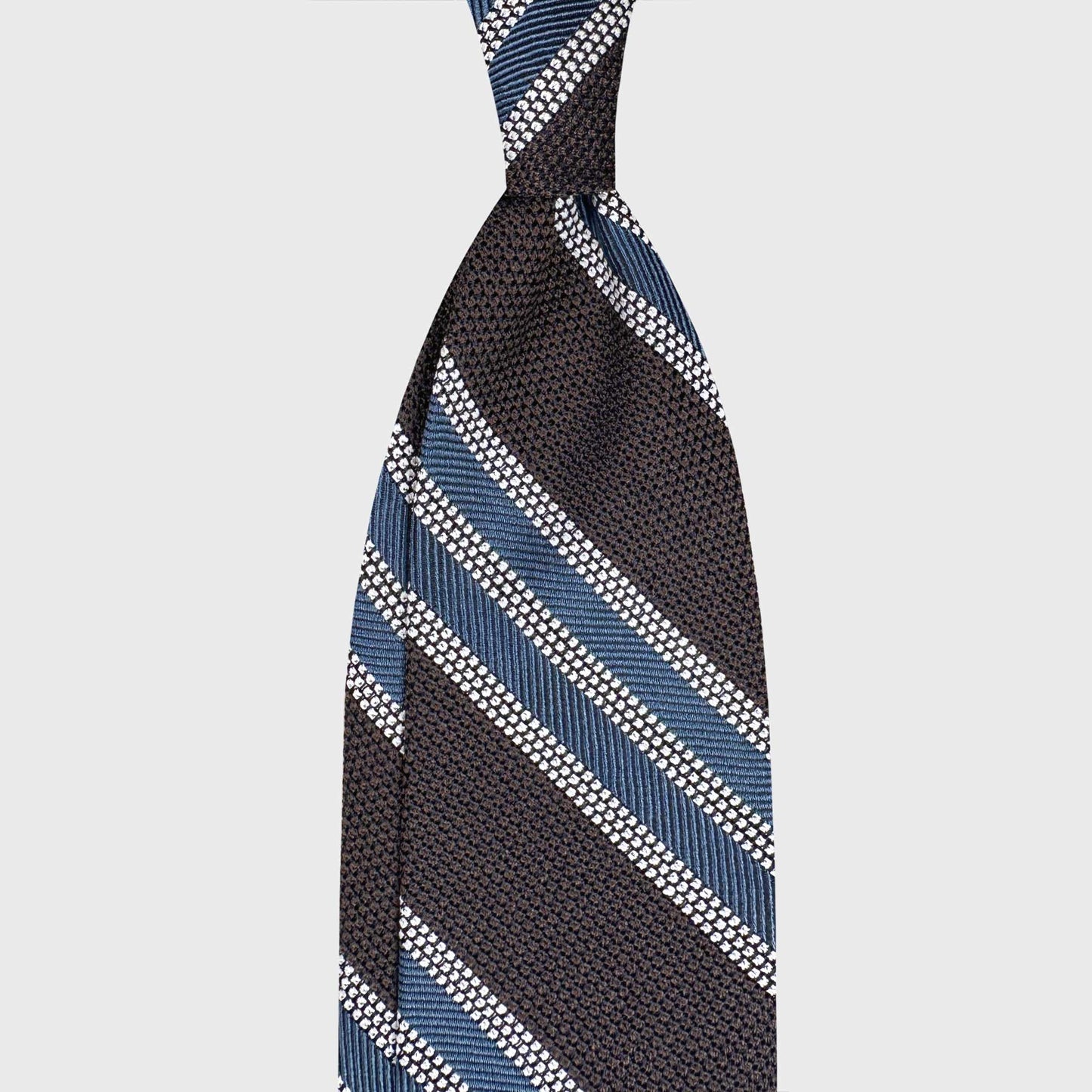 Handmade F.Marino grenadine silk regimental tie in coffee brown with pervinca blue and silver stripes. Crafted in Naples for Wools Boutique Uomo Geneva.