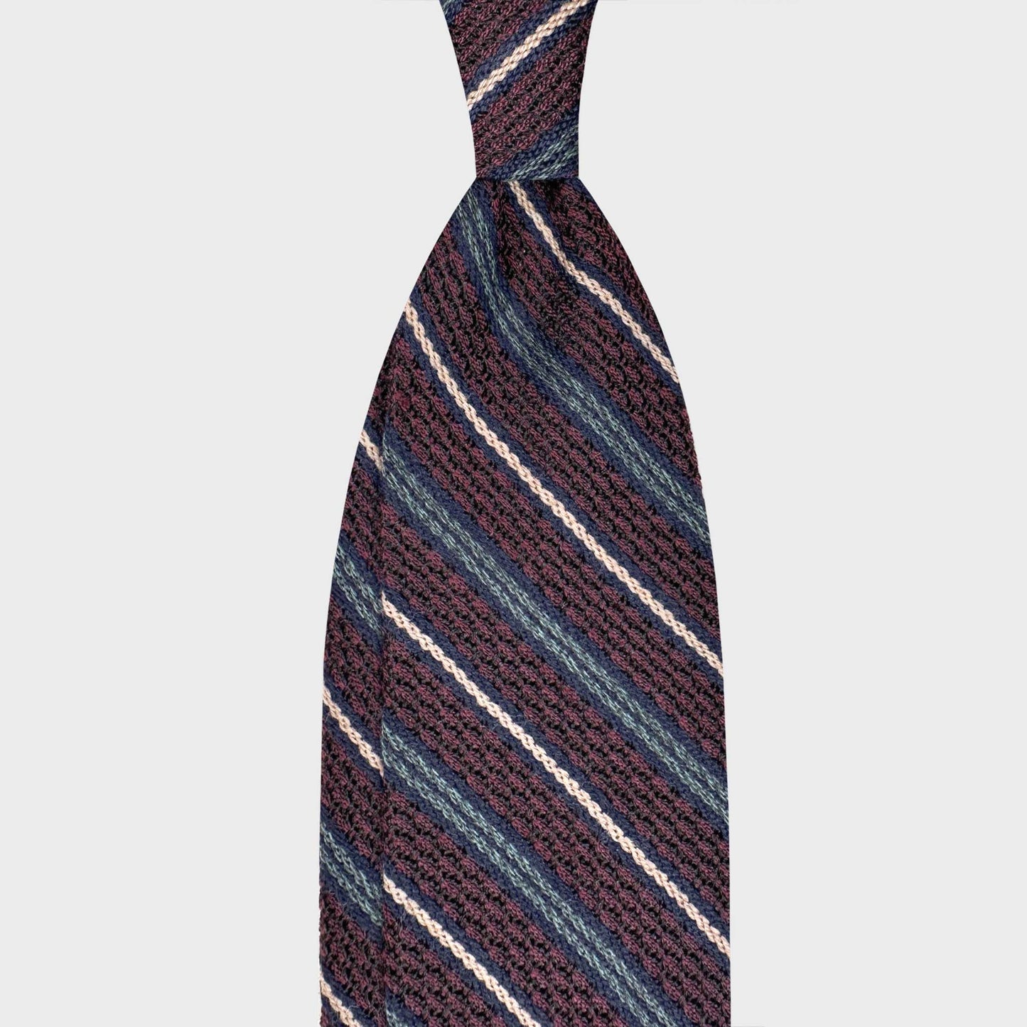 Handmade F.Marino grenadine large gauze silk tie in burgundy wine with teal, navy and ivory regimental stripes. Crafted in Naples for Wools Boutique Uomo Geneva.