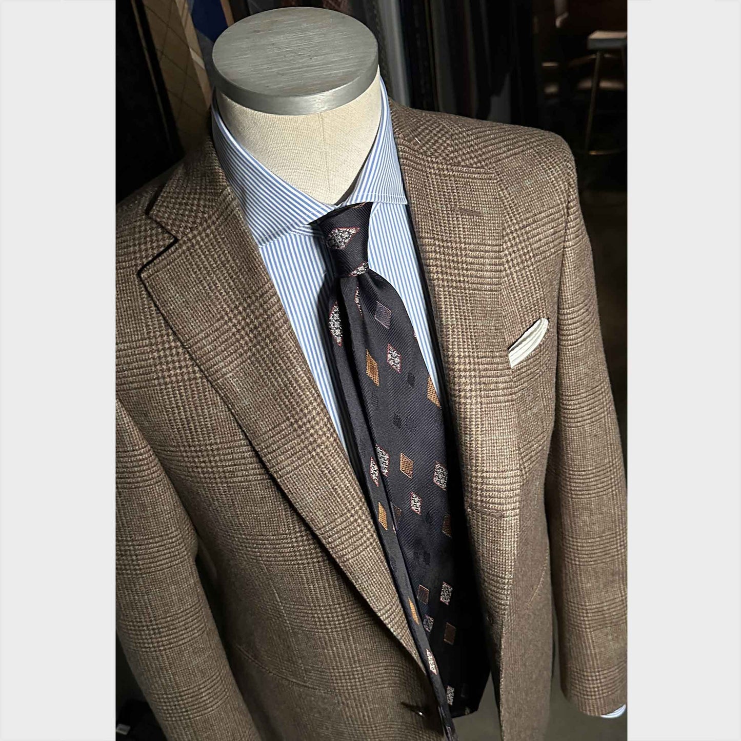 Outfit for Navy blue silk tie featuring classic diamond medallions in light blue and bronze tones.