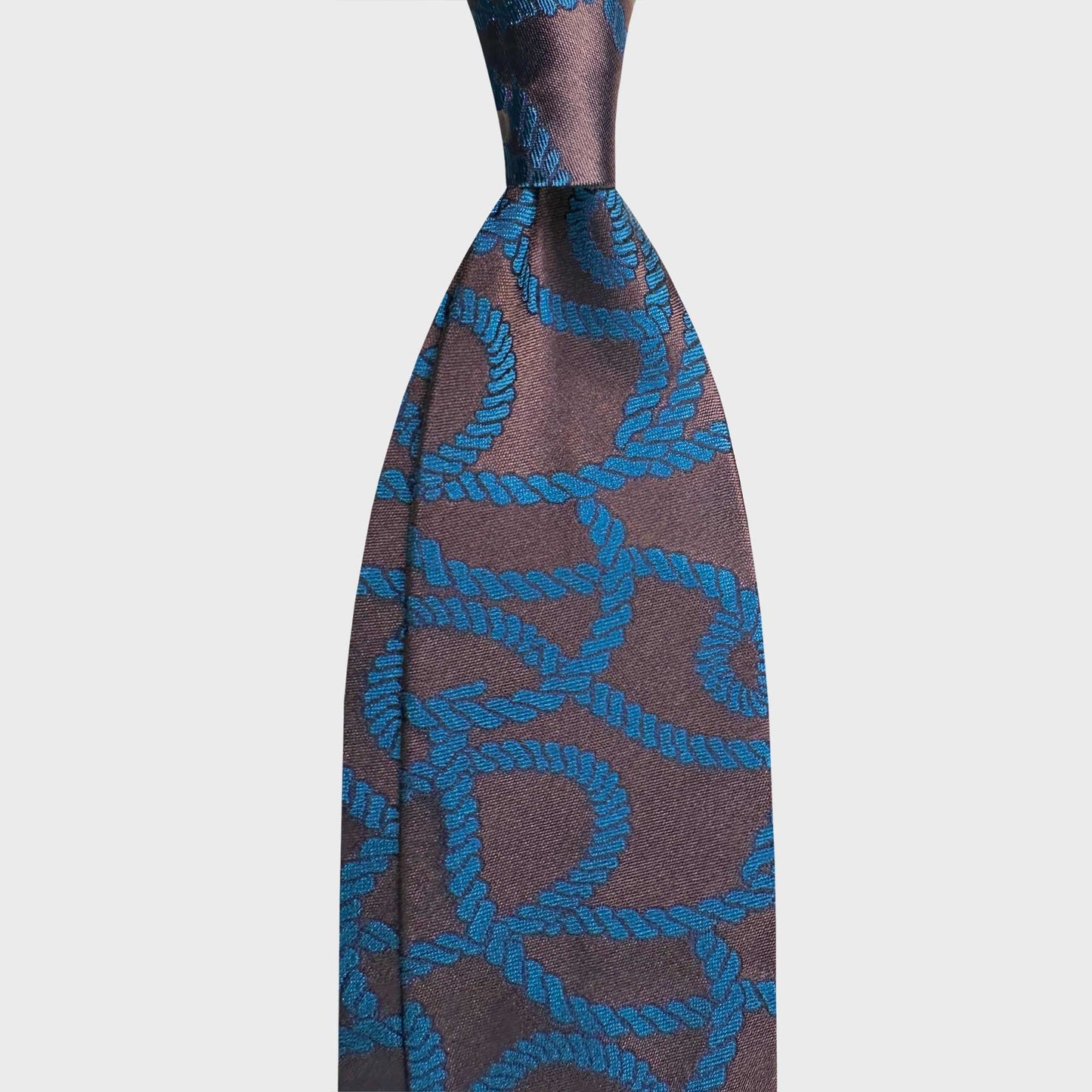 Bronze silk tie featuring an elegant turquoise rope pattern. A refined statement piece that blends nautical inspiration with contemporary Italian craftsmanship, ideal for distinctive formal and smart business looks.