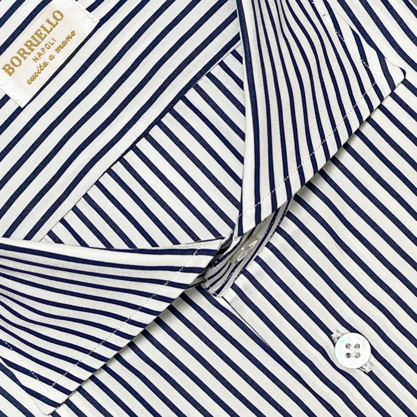 Classic blue striped shirt made with Thomas Mason fabric yarn-dyed in popeline cotton. Handmade shirt by Borriello Napoli exclusive for Wools Boutique Uomo, ideal both for the office and for more formal occasions with a bright appearance and a soft and smooth hand.
