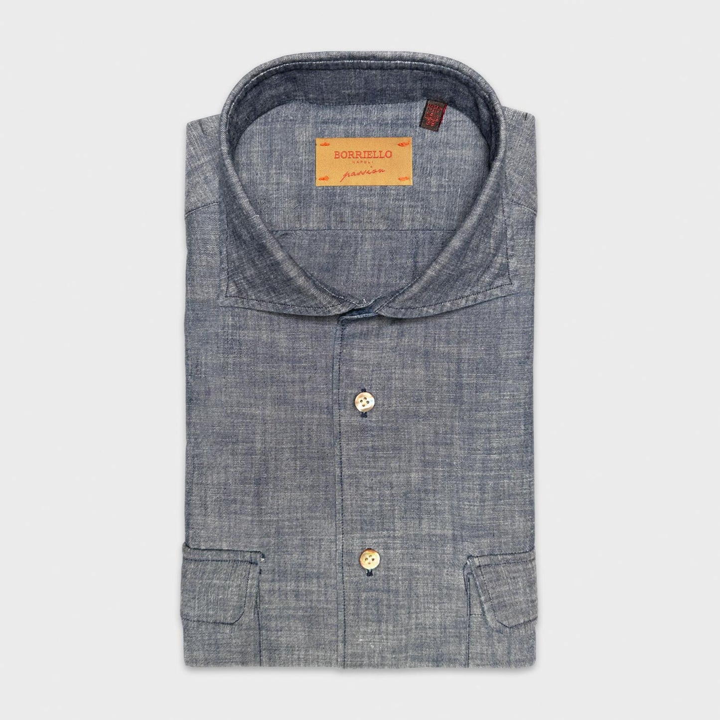 Safari Shirt Chambray Cotton Indigo Navy. Men's safari shirt handmade in Italy by Borriello Napoli. The model of this sporty shirt is originally designed for safari trips, it has always been appreciated for its comfort with four pockets in the front, always trendy in this flamed indigo navy color.