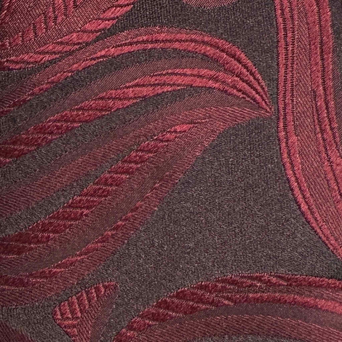 Details of Coffee brown silk tie featuring a contemporary Art Nouveau design in rich ruby red tones.