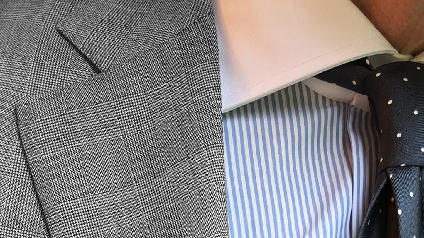 This pearl grey Prince of Wales suit, proposed by Wools Boutique Uomo for the spring summer season, combines a lightweight construction with refined wool 130s fabric by the historic English mill John Foster. The elegant checked pattern offers a sophisticated and contemporary alternative to plain business tailoring, while maintaining the same level of versatility and formal elegance expected from a classic menswear wardrobe.