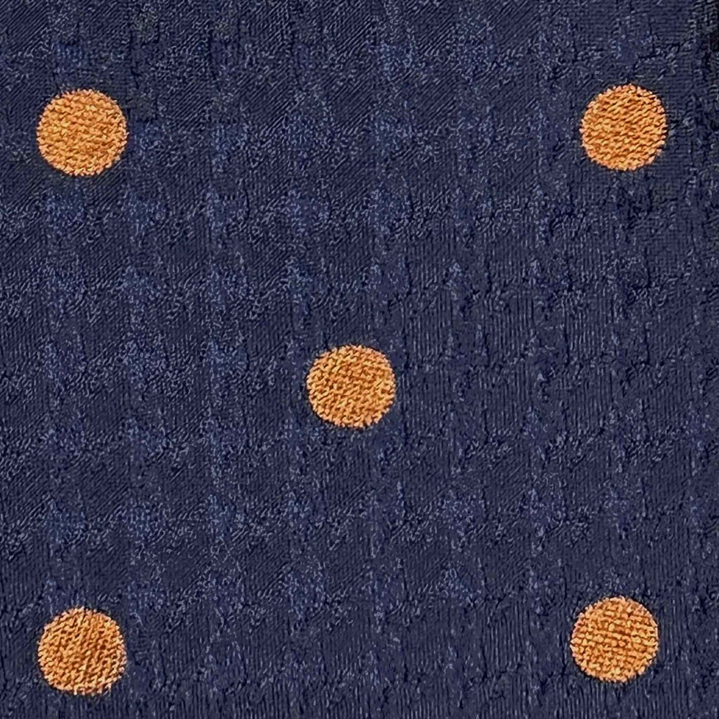 Detail of copper orange bold pois on cobalt blue textured silk tie