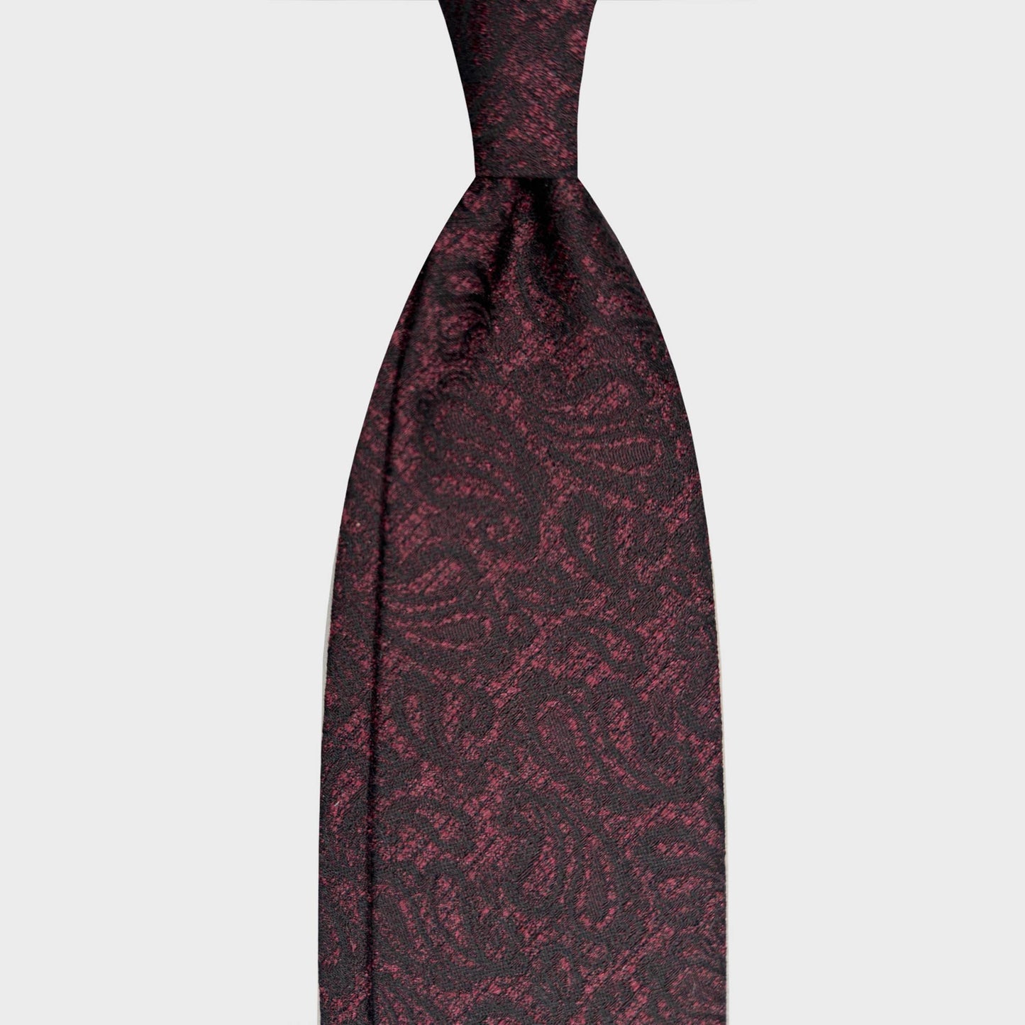 Magenta Silk Tie Paisley Pattern Italian Craftsmanship. Elegant paisley silk tie in magenta and navy tones. Handmade in Italy and selected by Wools Boutique Uomo Geneva for refined business and sartorial wardrobes.