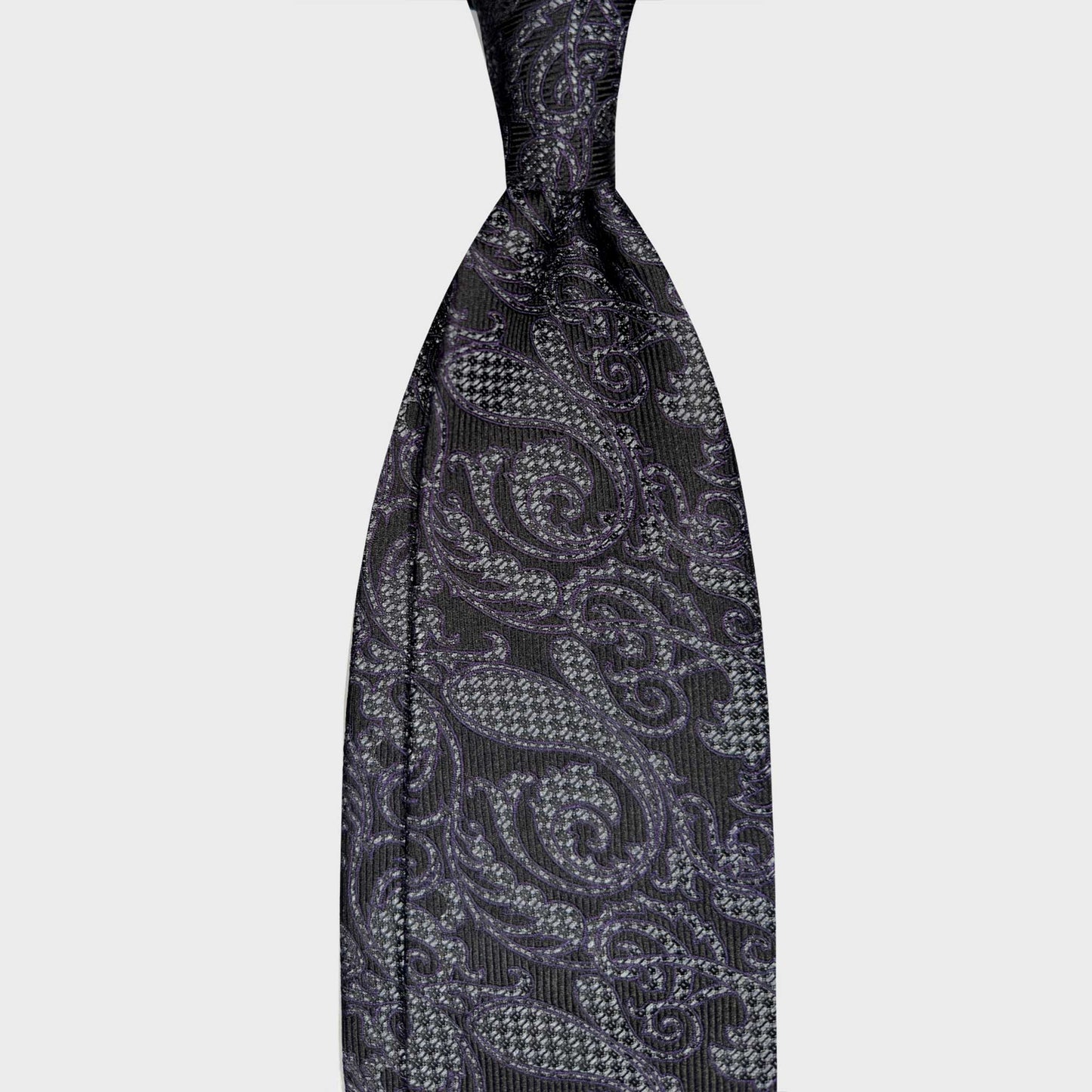 Grey Silk Tie Ornamental Paisley Pattern Italian Craftsmanship. Refined ornamental paisley silk tie in silver grey, violet and navy tones. Handmade in Italy and selected by Wools Boutique Uomo Geneva ties store.