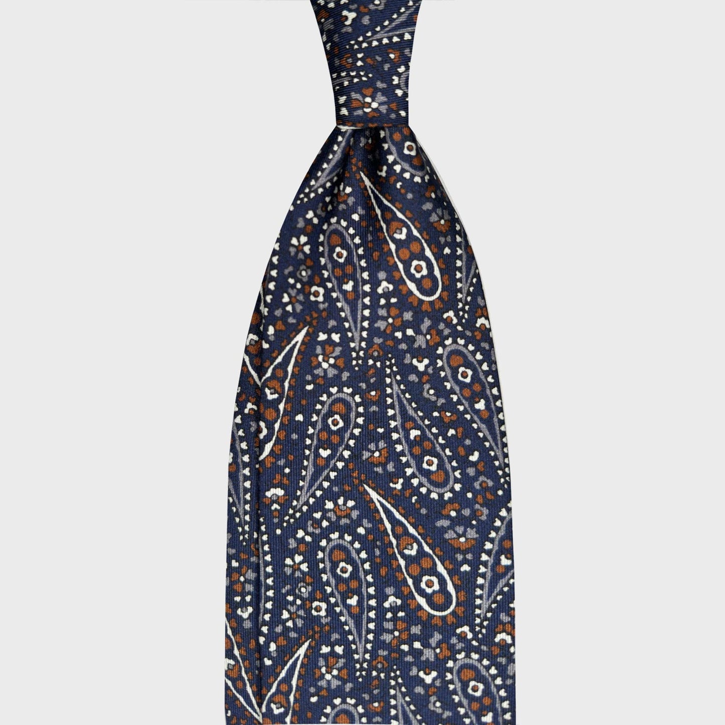 Men's Batik Paisley Silk Tie Handmade in Italy. Denim blue batik paisley silk tie with white, light blue and brown details. Handcrafted in Italy and selected by Wools Boutique Uomo Geneva handmade men's ties.