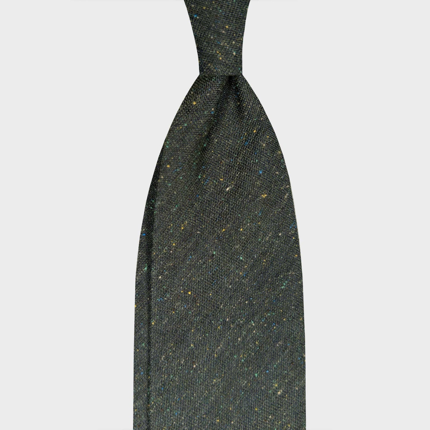 Green Silk Tie Donegal Pattern Italian Craftsmanship. Mud green silk tie with Donegal-effect flecks in yellow, light blue and white. Handmade in Italy and selected by Wools Boutique Uomo Geneva ties shop.