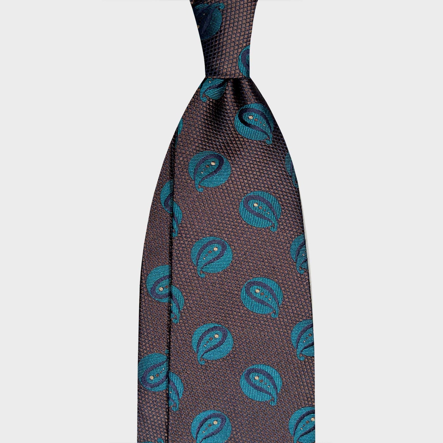 Art Déco Paisley Pattern Silk Tie Coffee Brown Heritage Men's Style. Brown Art Déco paisley silk tie handmade in Italy. A refined luxury tie selected by Wools Boutique Uomo Geneva for elegant business and sartorial wardrobes.
