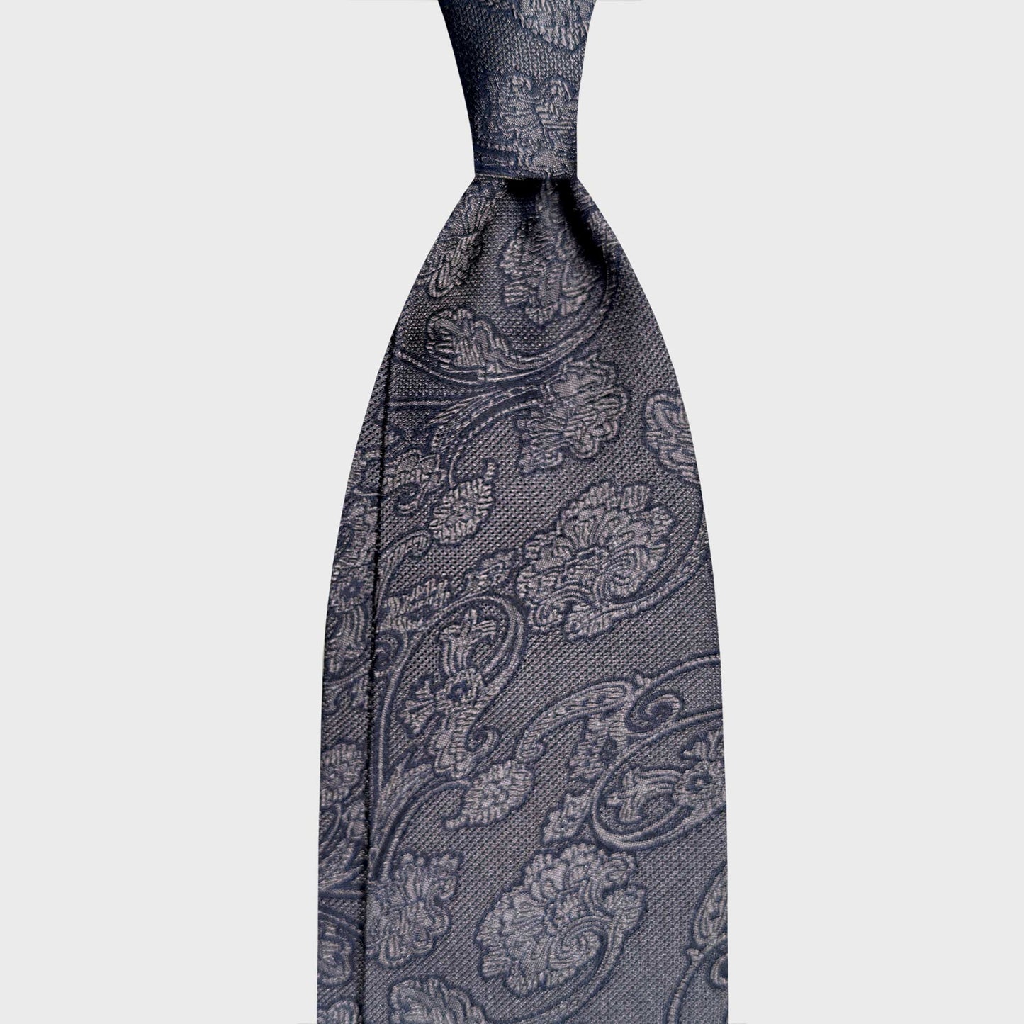 Iron Grey Silk Tie Liberty Botanic Pattern Heritage Men's Style. Refined Liberty botanic silk tie in melange navy blue. Handmade in Italy and selected by Wools Boutique Uomo Geneva for elegant business and tailored wardrobes.