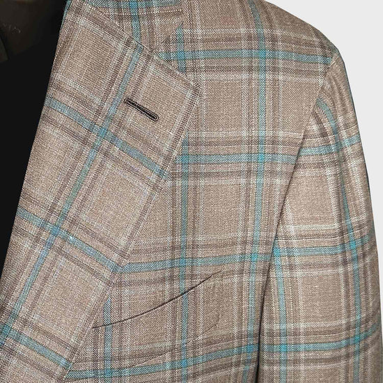 This Caruso men's tailored jacket crafted in Italy for Wools Boutique Uomo, vintage charm with a stonewall background color with a elegant turquoise and coffee brown windowpane pattern. Unlined for a relaxed feel, it effortlessly complements both formal office outfit with tie and leisurely.