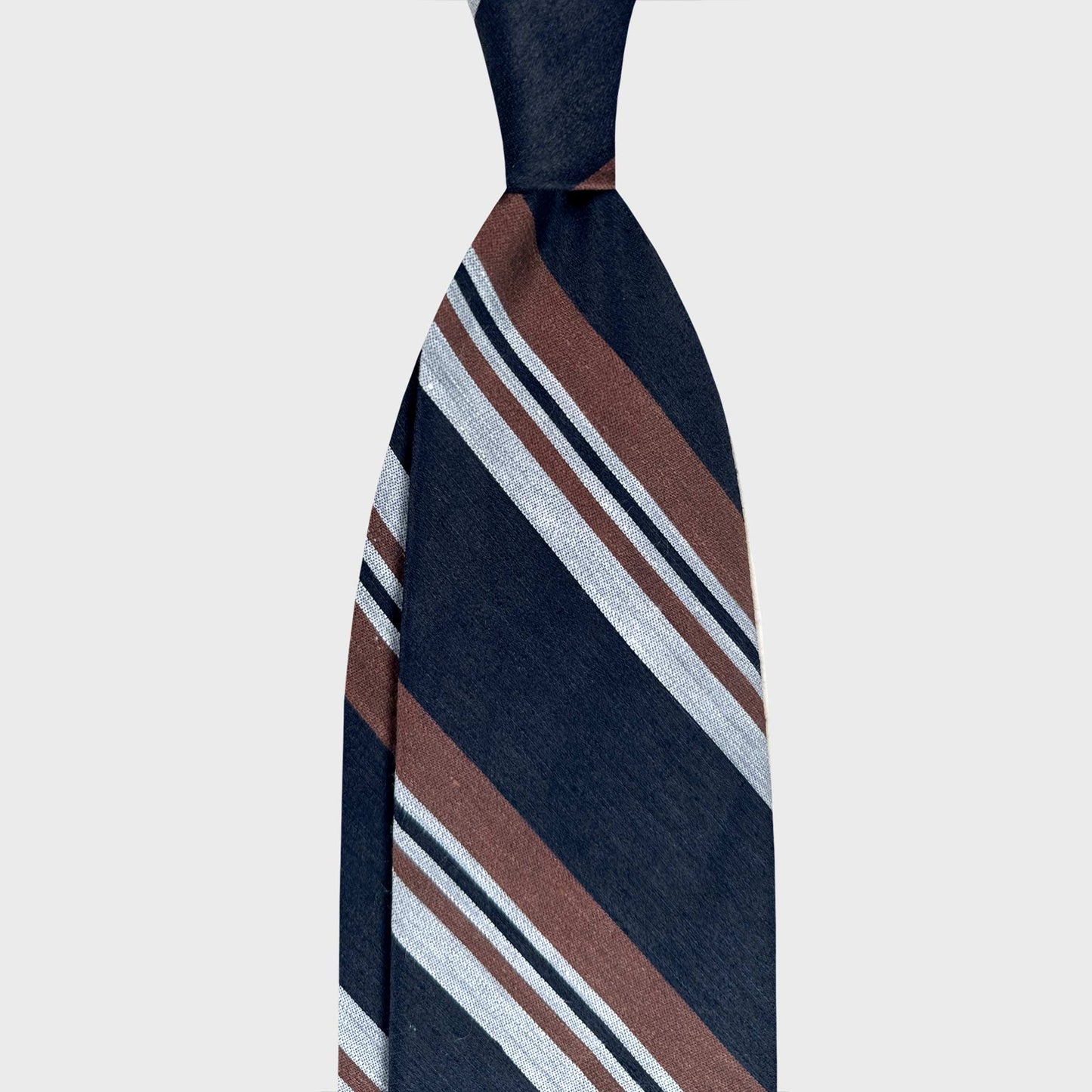 F.Marino linen silk regimental tie in navy blue with caramel and ivory stripes. Handmade in Naples for Wools Boutique Uomo Geneva.