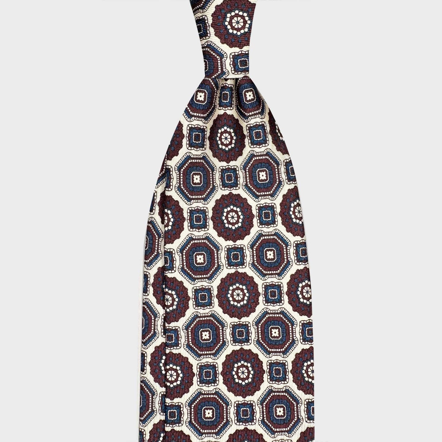 White Tie Silk Maiolica Pattern Handmade in Italy. White silk tie handmade in Italy by Wools Boutique Uomo, a destination for luxury men's ties, sartorial accessories and Italian ties in Geneva.