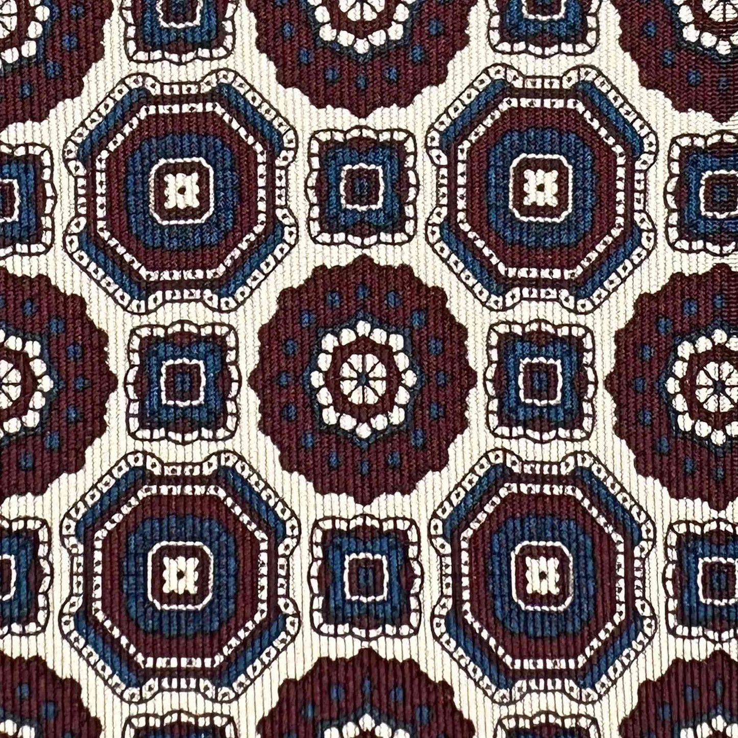 Detail of Maiolica pattern silk tie in white burgundy and navy