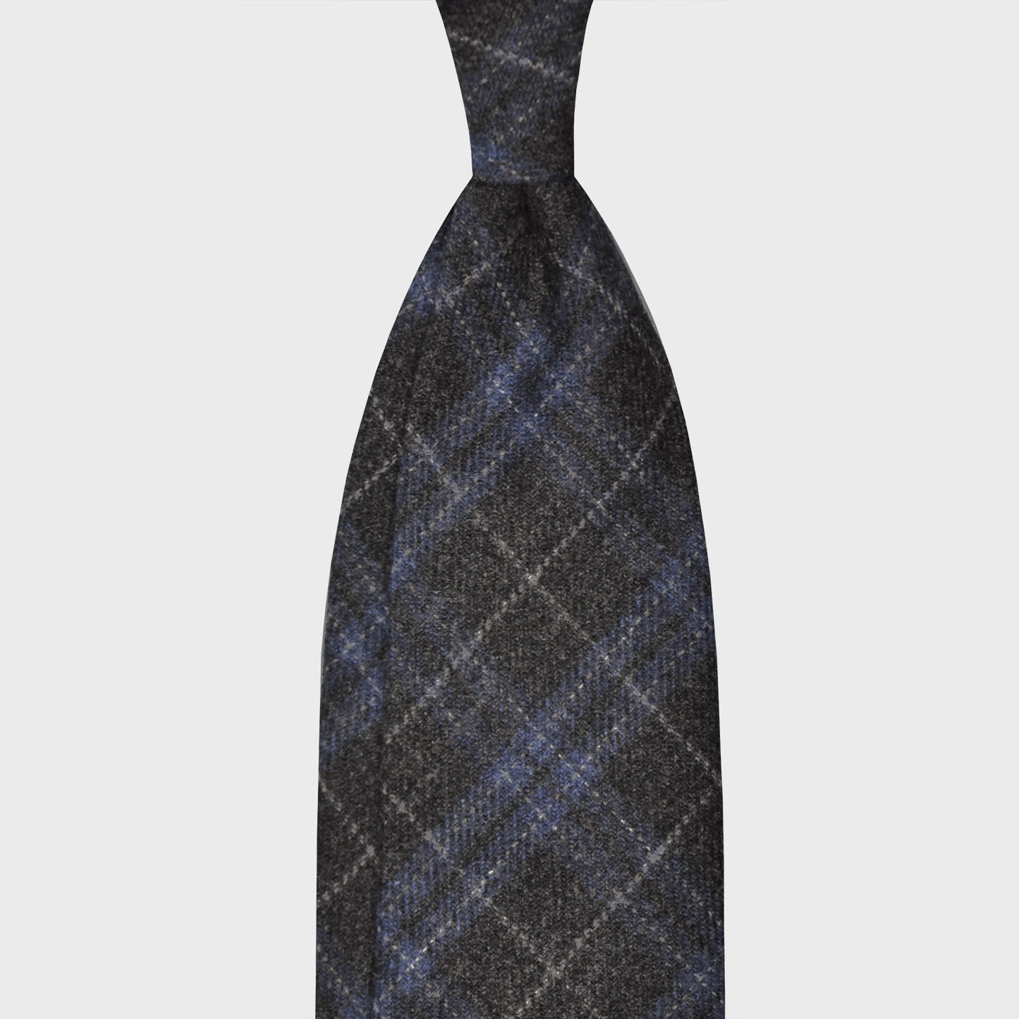 Load image into Gallery viewer, Grey Windowpane Flannel Wool Tie 3 Folds Unlined F.Marino. Soft and refined flannel wool tie, handmade F.Marino for Wools Boutique Uomo, hand rolled edge, anthracite grey background, ice grey and pervinca blue windowpane pattern.
