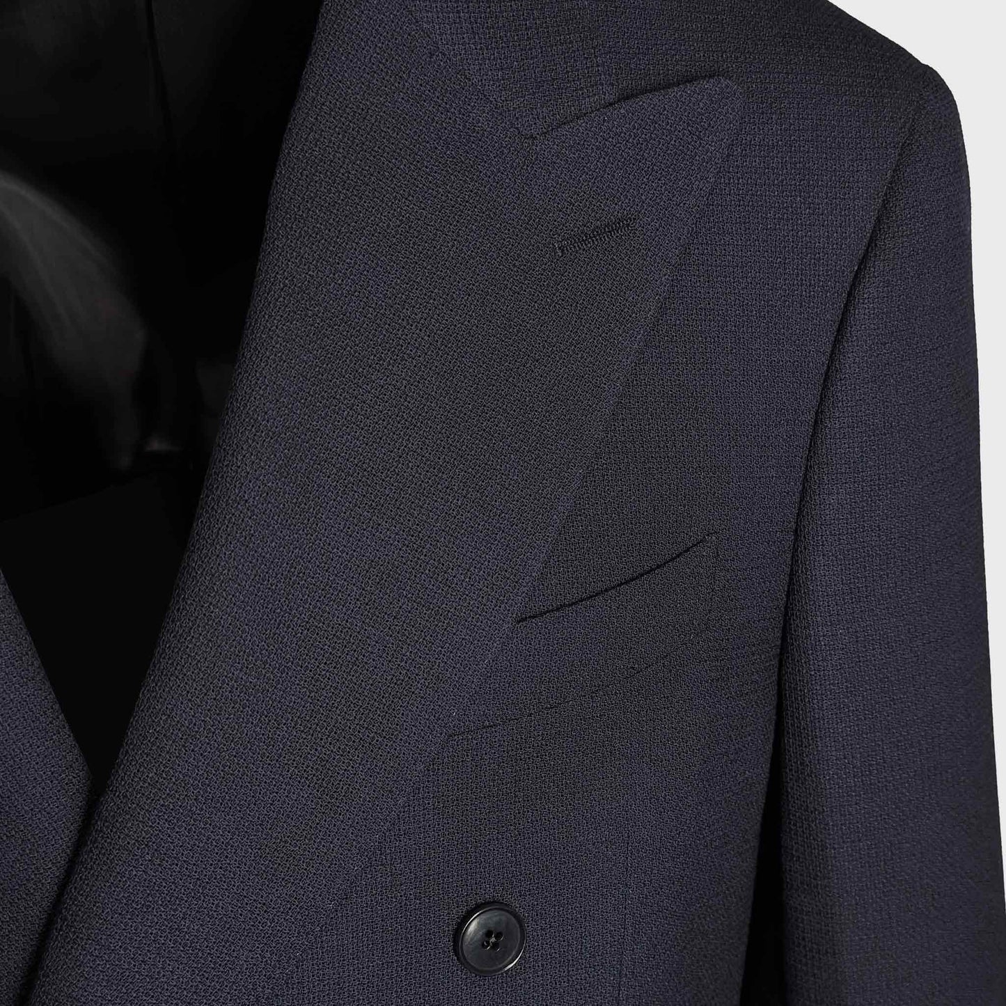 Detail of Marling & Evans navy blue hopsack wool fabric on double breasted jacket