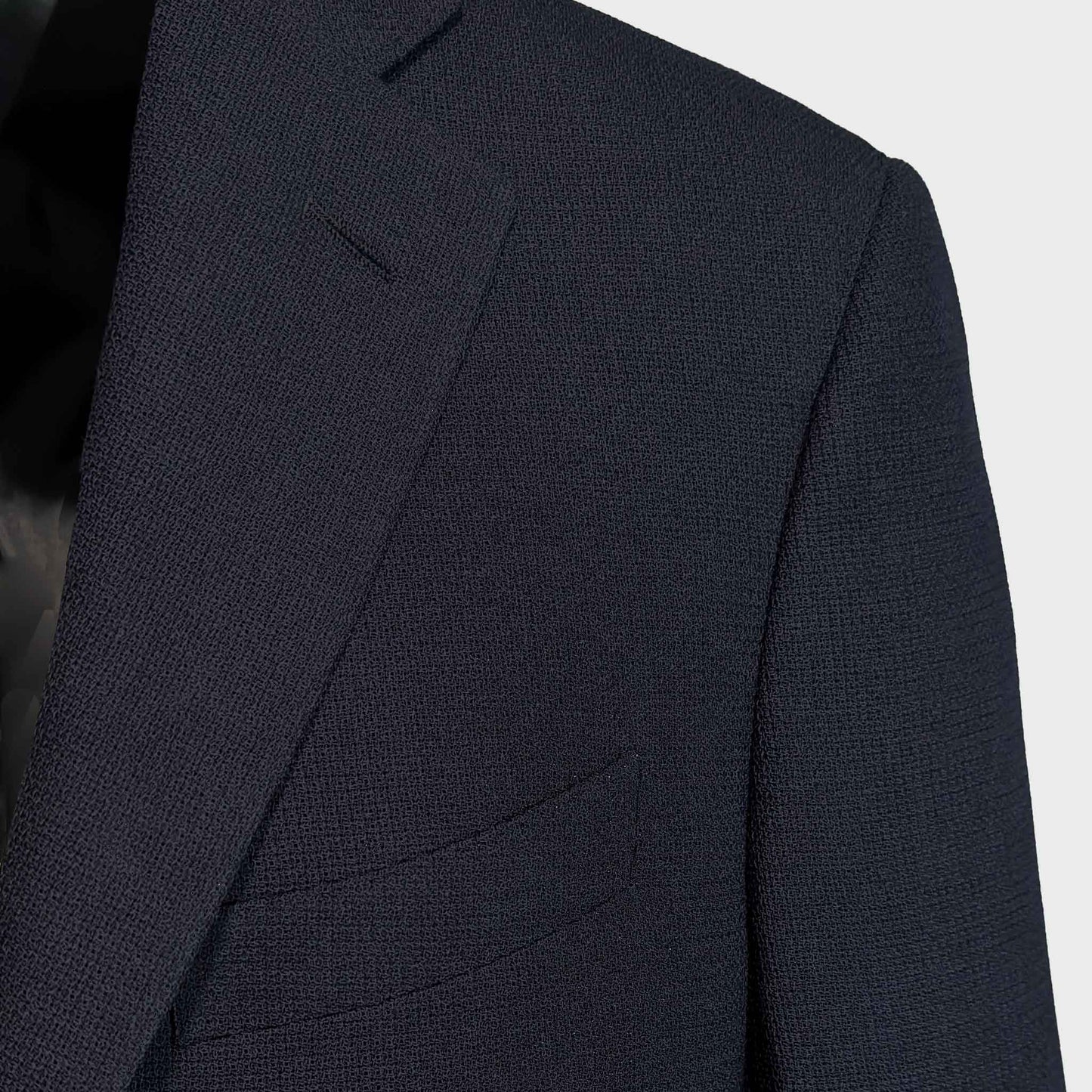 Detail of Marling & Evans navy blue hopsack wool texture on tailoring jacket