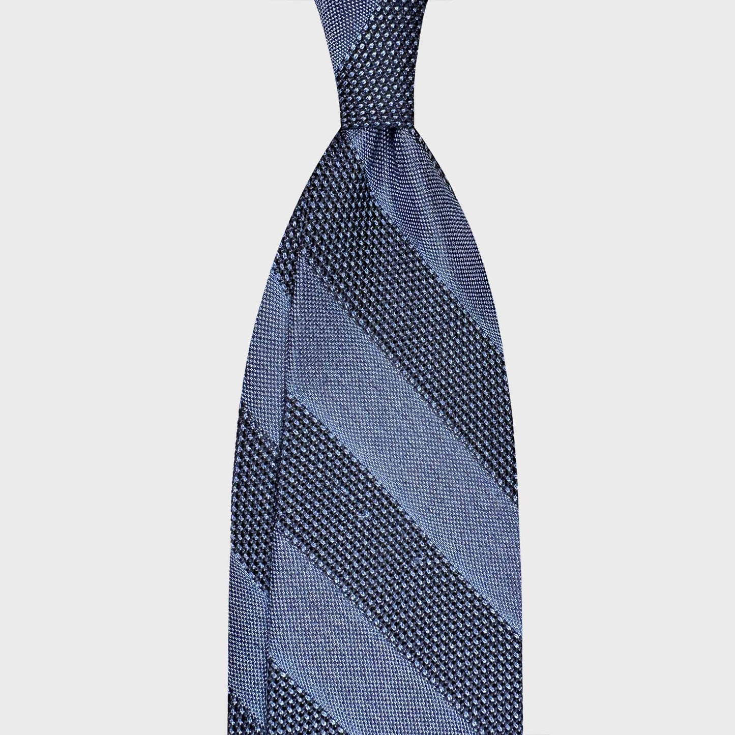 Handmade F.Marino grenadine silk regimental tie in cerulean and steel blue. Crafted in Naples with textured grenadine silk and available at Wools Boutique Uomo Geneva.