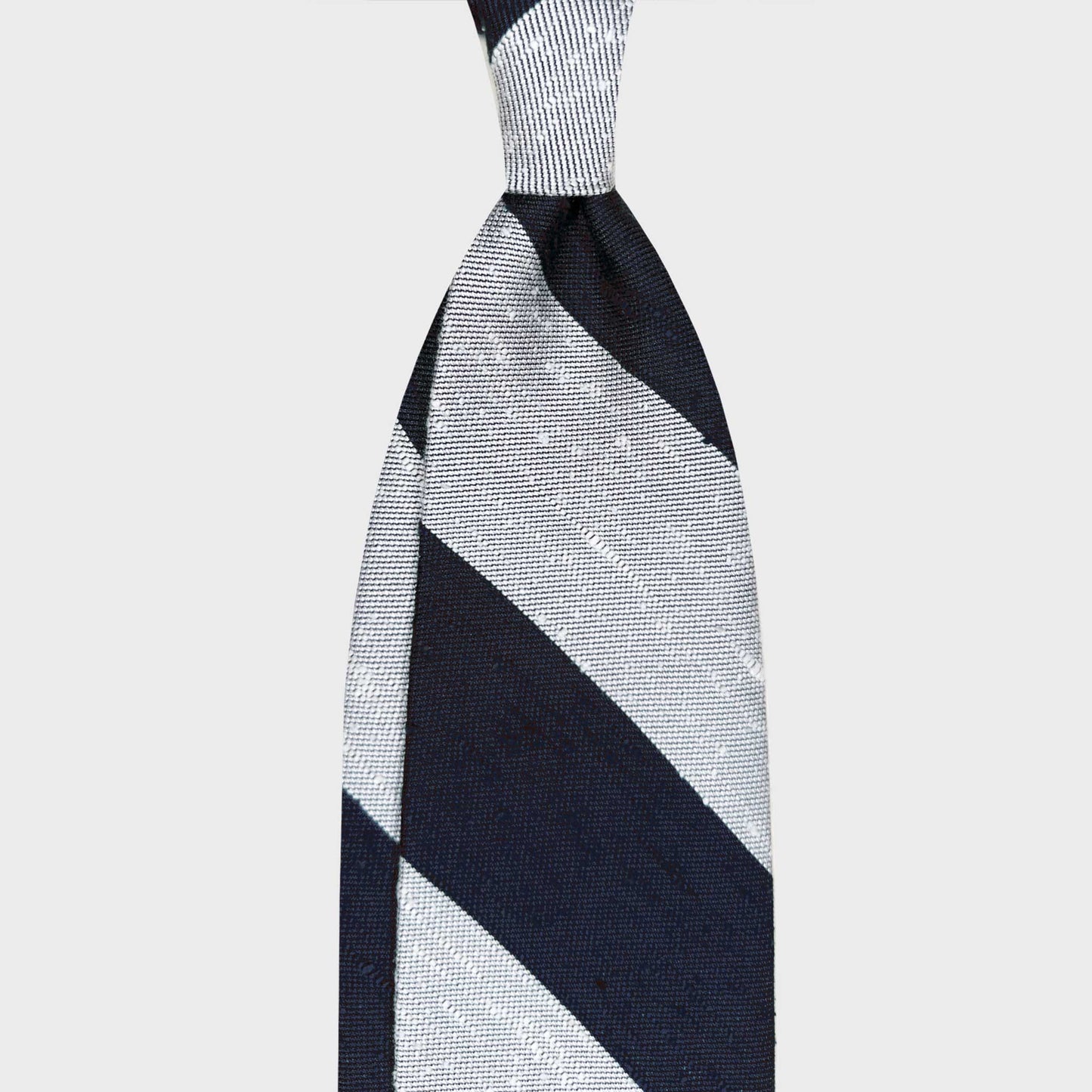 Discover the elegance of a Wools Boutique Uomo Geneva shantung silk tie in navy blue and ivory. Handmade in Italy with a refined textured weave, perfect for business and smart casual outfits all year round.