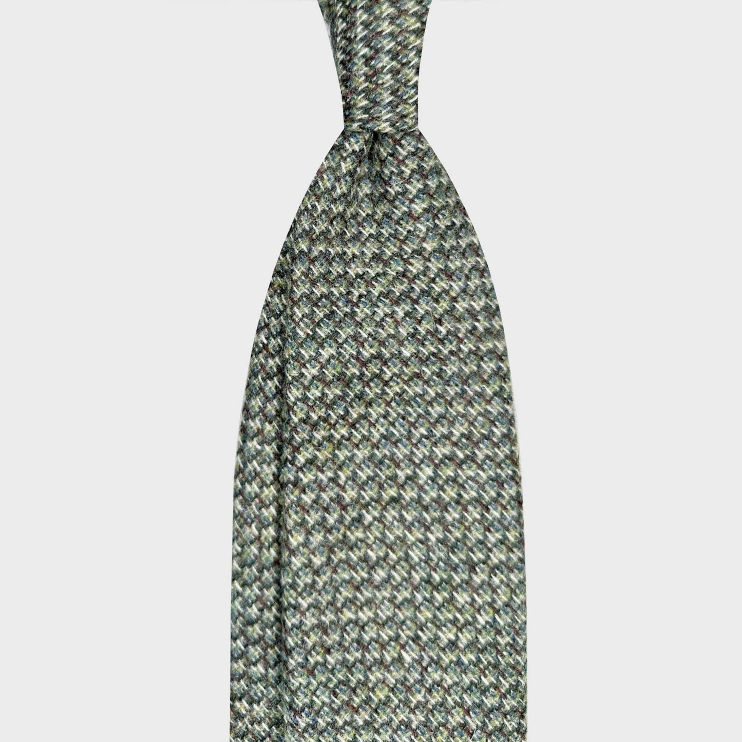 Green Wool Tie Mélange Basket Weave Unlined Hand Made in Italy. Refined wool green tie made with carded wool woven basket weave fabric, soft to the touch, discover at Wools Boutique Uomo men's ties store in Geneva